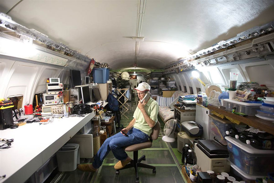 Man living in a commercial airliner in the woods