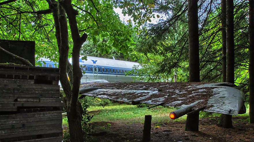 Man living in a commercial airliner in the woods