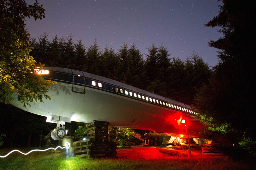 Man living in a commercial airliner in the woods